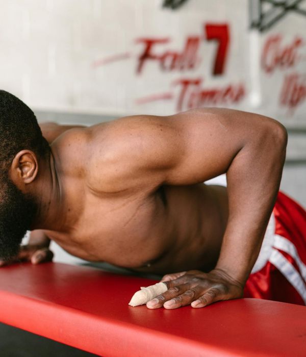 Man performing a controlled bodyweight exercise in a calm, focused environment.